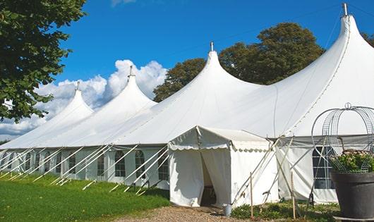 a row of portable restrooms placed outdoors for attendees of a special event in Bingham Farms